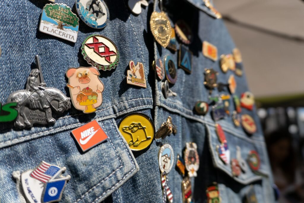 Close-up of vibrant pins on a denim jacket at a market in Guadalajara.